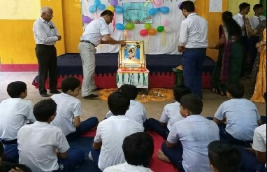 Teachers and students at a school assembly, Raghumal Arya Vidyalaya